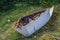 Small Cadet sailboat wreck in grass