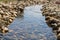 Small calm stream. Stream surrounded by rocks.