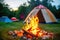 small campfire burning in front of a colorful tent