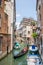 Small canal with gondola in Venice, Italy.