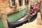 Small canal with parked gondola in Venice, Italy