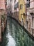 Small canal in venice with elegant old buildings reflected