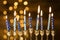 Small candles menorah near abstract lights. High quality and resolution beautiful photo concept