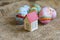 Small cardboard house with a red roof, Easter painted eggs