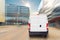 Small cargo delivery van driving in european city central district. Medium lorry minivan courier vehicle deliver package at