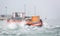 Small cargo transport boat with wooden crate ploughing through waves on the canal in Venice, Italy
