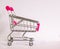 Small cart with pink handle on white background. Cutest decoration.