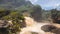 Small cascade flowing in the river jungle with huge rocks covered in greenery.