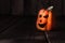 Small ceramic Halloween pumpkin. Trick or treat scary spooky grinning Jack-o\\\'-lantern face decoration.