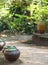 Small ceramics vase, water jar on vintage retro style house terrace