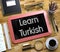 Small Chalkboard with Learn Turkish. 3D Illustration.