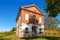 Small chapel among colorful autumnal vineyards in Piedmont, Italy