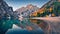 Small chapel on the shore of Braies Lake. Wonderful autumn scene of Dolomite Alps