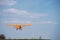 Small charter aircraft flying in a blue sky