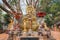 Small chedi surrounded by Buddha status at Wat Jed Yod, Chiang Mai, Thailand