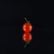 Small chery tomato on a black background