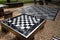 A small chess table in the park. Empty board game table