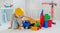 Small child 4 years old, playing with a large number of colorful plastic toys in the room, construction of various