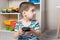 A small child boy 3-4 years old looks into the phone screen. Parental control of content, internet and cartoons in the