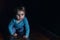 Small child crawls on all fours on a soft tunnel of mats.