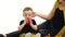 Small child eats an apple, next to her mother. White background