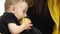 Small child eats an apple, next to her mother. White background. Slow motion. Close up