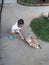 a small child is feeding a rabbit in the park