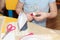 Small child hands glue paper crafts at school desk