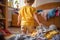 A small child helps sort out the laundry for washing.