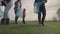 A small child with his parents collects trash in a park recreation area, group cleaning of the territory, ecology of