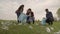 A small child with his parents collects trash in a park recreation area, group cleaning of the territory, ecology of