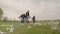 A small child with his parents collects trash in a park recreation area, group cleaning of the territory, ecology of