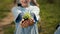 Small child holding soil with a green sprout in her hands