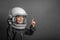 small child imagines himself to be an astronaut in an astronaut`s helmet