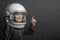 small child imagines himself to be an astronaut in an astronaut`s helmet