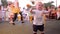 Small child joyfully jumps and waving his hands on unfocused background of people close-up