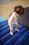 The small child jumps on an inflatable mattress