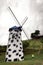 Small child looking at a tall windmill in Cingjing, Taiwan