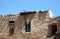 A small child looks from a doorway in a house in Ghazni, Afghanistan