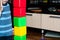 A small child playing with colorful cubes builds a tower, the concept of early education preparation for the development of the