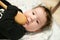 A small child is playing with a spoon. old kitchen toys. close up of babies hands playing with wooden spoon and pot baby chef