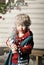 Small child presses a bottle with artificial snow