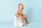 A small child is sitting on a potty and crying. Diarrhea and bloating in a newborn