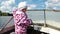 Small child standing near steering wheel in motorboat, Valday, Russia