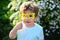 Small child with summer party glasses. Little boy child in green forest. spring holiday. Sunny weather. Happy kid in