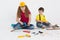 Small children builders construction helmet build or repair wooden things on a white background