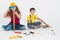 Small children builders construction helmet build or repair wooden things on a white background