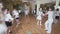 Small children group learns active joyful dance in class
