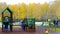 Small children play with parents on playground at birches