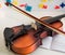 A Small Children`s Violin and Bow on a Child`s Study Desk